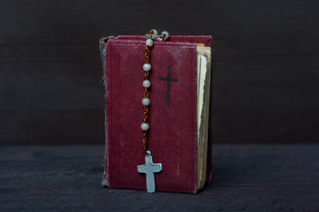 Wall Mural - Bible and rosary beads on wooden vintage background