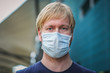 Coronavirus covid-19 disinfection. Portrait caucasian Men with a protective mask, biological hazard