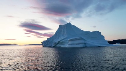 Wall Mural - Iceberg at sunset. Nature and landscapes of Greenland. Disko bay. West Greenland. Summer Midnight Sun and icebergs. Big blue ice in icefjord. Affected by climate change and global warming. Aerial view