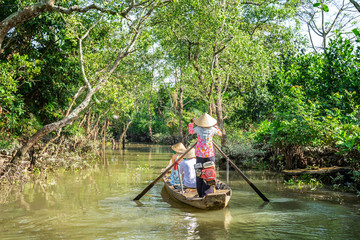 Tourists from China, Korea, America, Russia experiencing a basket boat tour at Tan Phong island or Cu Lao Tan Phong in Tien Giang, Vietnam. Near Ben Tre city.