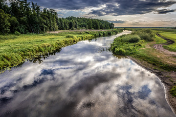 Sticker - Clouds reflecting in the Biebrza River, view from a bridge in Dolistowo village, Poland