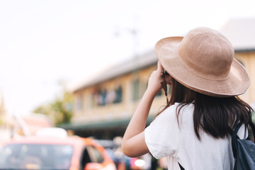 Young asian girl traveller sightseeing around Bangkok with camera.