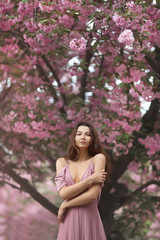 Wall Mural - Woman at Blossoming Sakura Tree on Nature