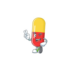 Wall Mural - Cheerful red yellow capsules mascot design with two fingers