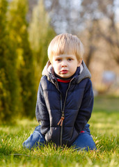 portrait of little model boy in nature