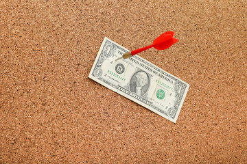 concept of successful work in the form of a hit target. dart pinned a dollar bill. making money concept