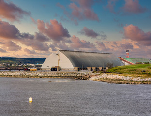 Wall Mural - A metal warehouse at an industrial port on the coast of Canada