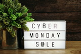 Fototapeta  - Cyber Monday Sale word in light box on wooden background