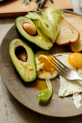 Wall Mural - Healthy breakfast: scrambled eggs, toast, avocado, lettuce, rosemary
