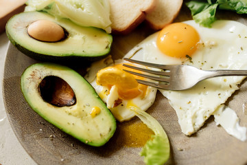 Wall Mural - Healthy breakfast: scrambled eggs, toast, avocado, lettuce, rosemary
