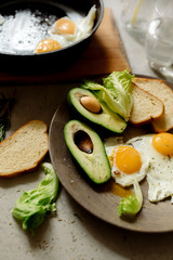 Wall Mural - Healthy breakfast: scrambled eggs, toast, avocado, lettuce, rosemary
