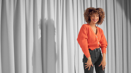 Canvas Print - Mixed race black woman with curly hair and natural warm make-up for dark skin Dancing and laughing