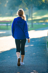 Wall Mural - middle-aged woman walking in city park