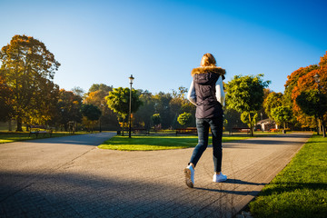Wall Mural - middle-aged woman walking in city park