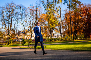 Wall Mural - middle-aged woman walking in city park