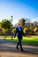 Wall Mural - middle-aged woman walking in city park