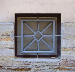 Wall Mural - A basement window with a metal barrier