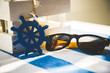 Okulary w blasku słońca leżące na stole nad morzem