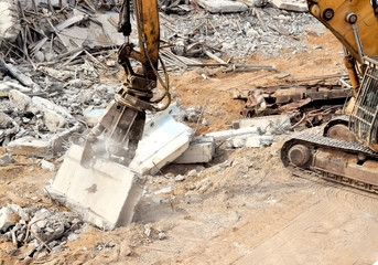 Wall Mural - Modern excavator at night parses debris with hydraulic pliers