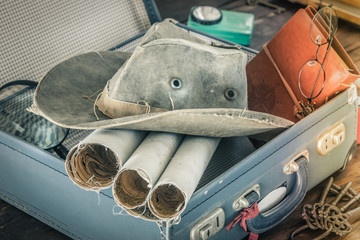 Aufkleber - Preparing for travel.  Packing the suitcase.  The concept of a great adventure.  Retro style.  Old maps, notebook, magnifier, combo hat packed into a stylish suitcase.  compass, flashlight, key ring, 