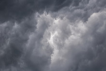 Light In The Dark And Dramatic Storm Clouds. Dark Storm Clouds Before Rain. Background Image In A Dark Gray Style.