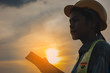 © Joke Phatrapong - Asian Industrial Engineers female Using Digital tablet on construction site and sunset background. industry and safety concept