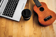 © Fran - Ukelele on a table with a laptop and a cap of coffee