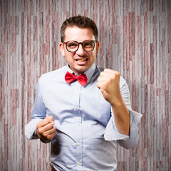 Man wearing a red bow tie. Looking upset.