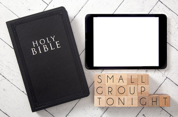 Wall Mural - Small Group Tonight in Block Letters on a White Wooden Table with a Black Bible and Tablet
