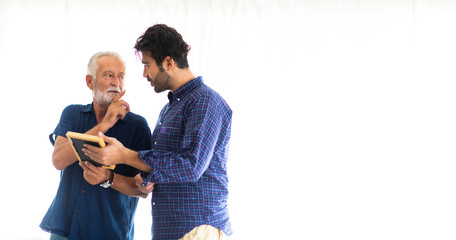 Wall Mural - Father and son family time together at home concept. Happy old father and son standing together and looking photos while remembering old times past in living room at home