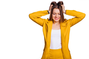 Wall Mural - young woman in a yellow trouser suit hold hands in her hair and