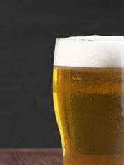 Close-up of a glass of lager foam. Bright refreshing alcoholic drink