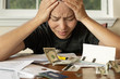 © globalmoments - Woman looking at her financial bills stressed out; No money/bankruptcy