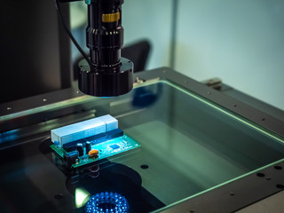 Poster - Production of electronic circuit boards. Checking chips in production. Automated processors manufacturing. Microscope is aimed at the electronic board. Manufacture of electronic chips. Light industry