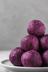 Wall Mural - Energy balls made of blueberries, acai, dates and nuts. Healthy vegan food dessert. vertical orientation