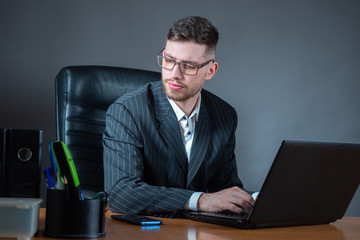 Poster - A man works in his office. The employee thought while working at the computer. A man works in an office. The lawyer draws up the contract. Remote work on the computer.