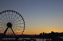 Silhouette Ferris Wheel Against Sky At Sunset