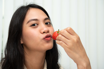 Woman eat strawberry red berry fruit sweet juicy