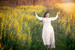© Possathorn - Asian women in Vietnamese clothes jump with joy in the Juncea Crotalaria flower fields.