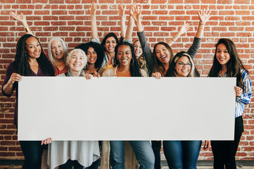 happy women holding empty banner