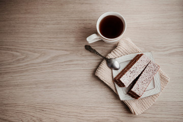 piece of cake lying on a saucer with a mug of tea