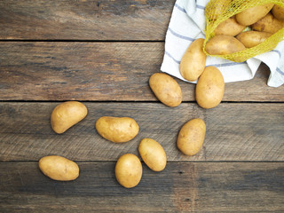 Potatoes on old wooden table.