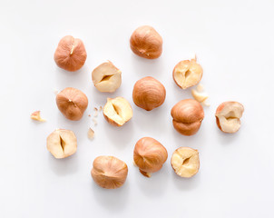 full and half of hazelnuts on white background top view. isolated