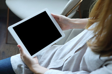 Business woman using tablet  with holding on wooden desk