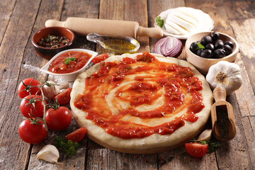 Wall Mural - raw dough pizza with tomato sauce, olive, cheese and oil