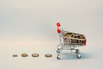 Shopping cart with Russian money. Metal coins and a souvenir shopping basket.