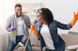 Happy Housekeeping. Cheerful African Couple Having Fun While Cleaning Home