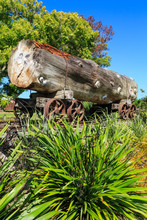 A Giant Kauri Log On A Vintage Rail Trolley In A Katikati, New Zealand Park, A Reminder Of Early 20th Century Logging