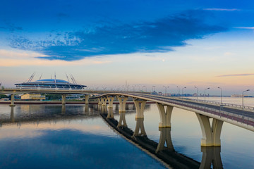 Wall Mural - Saint Petersburg. Russia. Bridge over Krestovsky island. Road Architecture of St. Petersburg. Large bypass bridge. A trestle over the bay. The bridge is reflected in the water. Russian roads