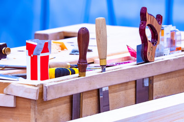Poster - Tools in a furniture workshop. Home-made place for tool storage. Tools are stored in suspension. Storage systems for the carpentry workshop. Joiner's workshop. Saw. Chisel. Carpenter's workplace